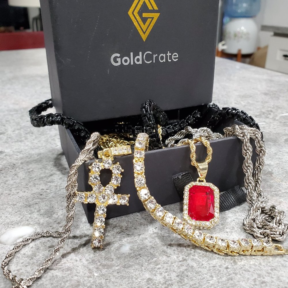 Gold Crate jewelry includes tennis bracelet,2 silver chains, cross pendent,